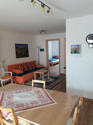 a living room with a table and a couch at Hofstatthof in Campo di Trens