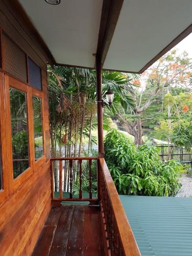 an empty porch of a house with a wooden porch at Songthai Suvarnabhumi in Ban Khlong Si