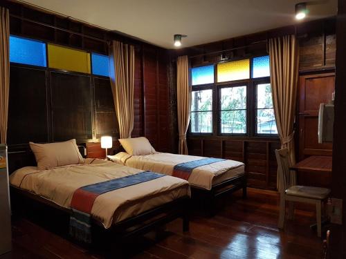 Кровать или кровати в номере Songthai Suvarnabhumi