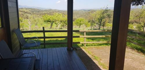 a screened porch with a view of a fence and trees at Agriturismo Sa Pigalva in Tula