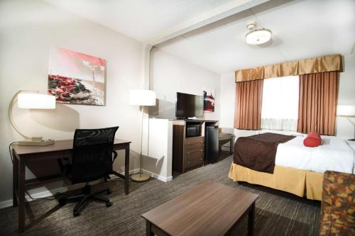 a hotel room with a bed and a desk at Best Western Plus Sandusky Hotel & Suites in Sandusky