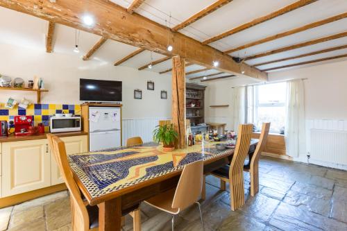 a kitchen with a dining room table and chairs at Bamse Self-Catering Ensuite Rooms with Shared Kitchen in Montrose