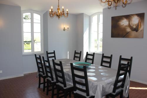 a dining room with a table and chairs at DOMAINE FORVENT in Saint-Julien-de-Peyrolas