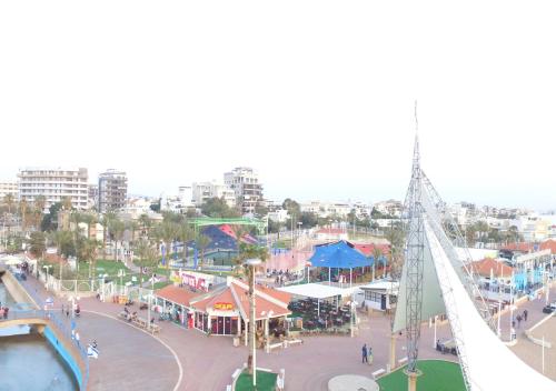 a view of a amusement park with a bridge at Balfour sea view city center in Nahariyya