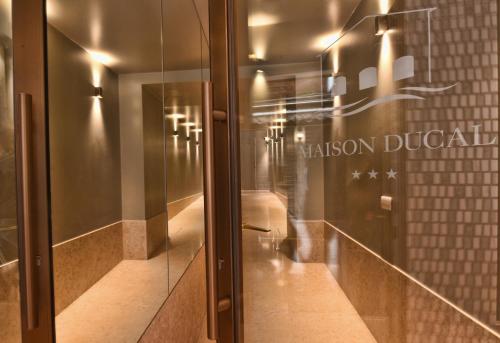 a hallway with a glass door in a building at Hotel Maison Ducal in Venice