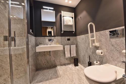 a bathroom with a toilet and a sink and a shower at Hotel Maison Ducal in Venice