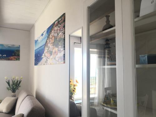 a living room with a couch and a mirror at Il Quadrifoglio in Massa Lubrense