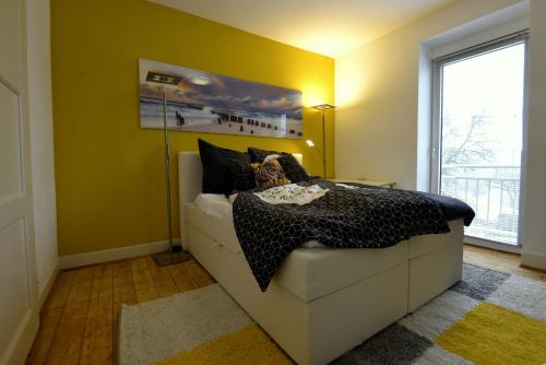 a bedroom with a bed and a yellow wall at Alte Schule 2 in Kall
