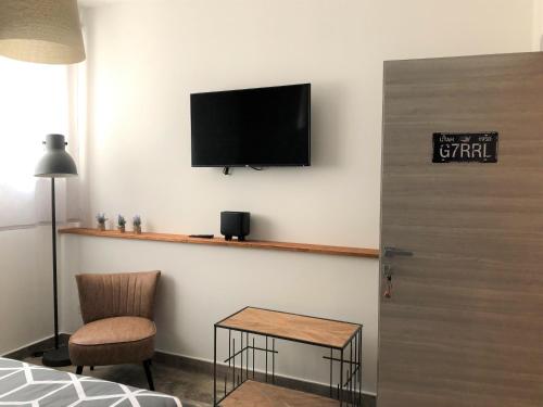 um quarto com uma televisão na parede e uma mesa em INDUSTRIAL CHIC HOUSE - Private parking em Orvieto