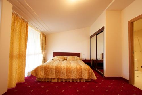a bedroom with a bed and a large window at Best Resort Aghveran in Arzakan