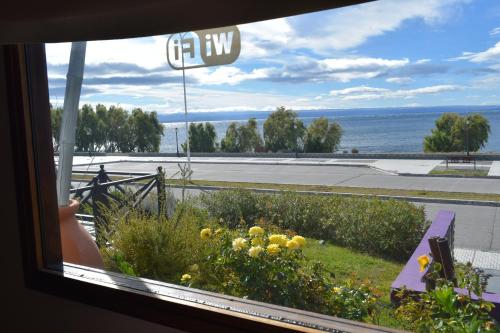 a view of the ocean from a window with a view at Hotel Mora in Los Antiguos