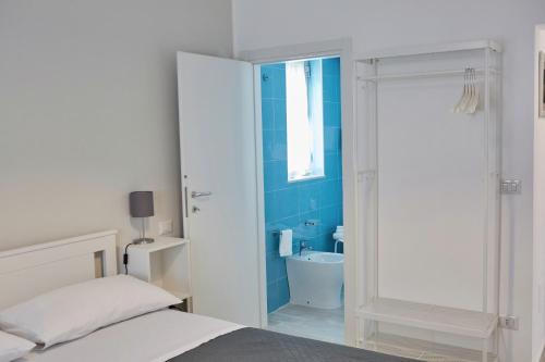 a bedroom with a bed and a bathroom with a shower at SoleeMare Barletta in Barletta