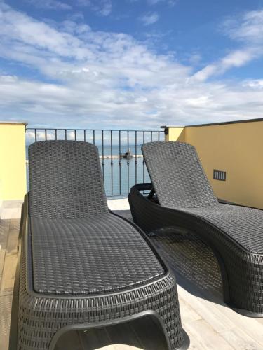 two chairs on a balcony with a view of the ocean at Vento di mare in Procida