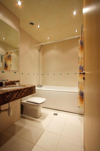 a bathroom with a toilet and a tub and a sink at Best Resort Aghveran in Arzakan