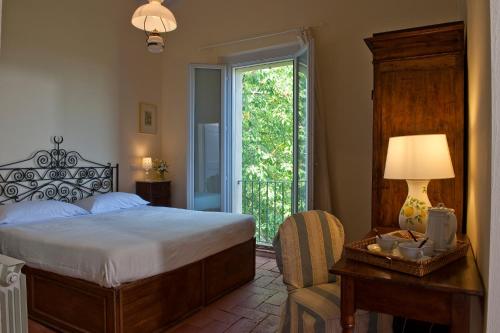 a bedroom with a bed and a table with a lamp at Podere San Quirico in Castelnuovo Berardenga