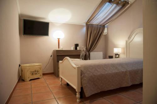 a bedroom with a bed and a flat screen tv at RESIDENZA D'ORIA B&B in Foggia