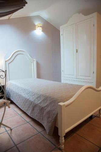 a bedroom with a white bed and a white cabinet at RESIDENZA D'ORIA B&B in Foggia