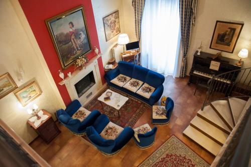 a living room with blue chairs and a fireplace at RESIDENZA D'ORIA B&B in Foggia