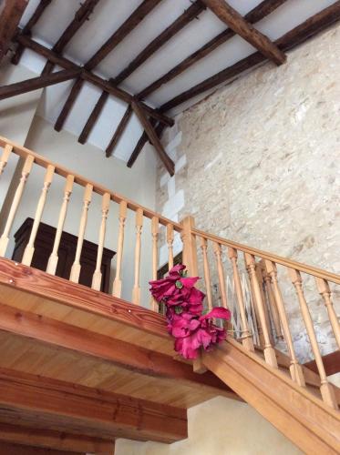 a wooden staircase with a potted plant on it at L'écurie Gite in Saint-Pierre-de-Côle