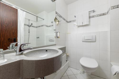 a bathroom with a sink and a toilet at Trip Inn Hotel Frankfurt Airport Rüsselsheim in Rüsselsheim
