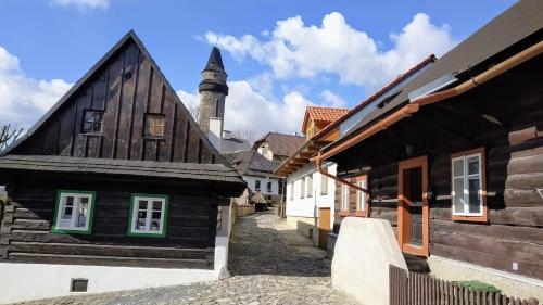 an alley in a medieval town with wooden buildings at Bílá hora Štramberk in Štramberk