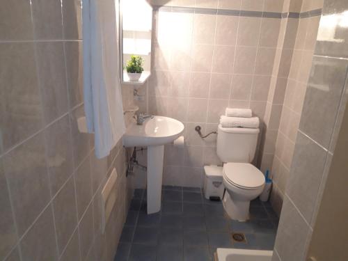 a small bathroom with a toilet and a sink at Sea Vessel in Balíon