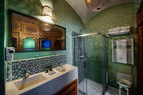 a bathroom with two sinks and a glass shower at Emma's Riad in Marrakesh