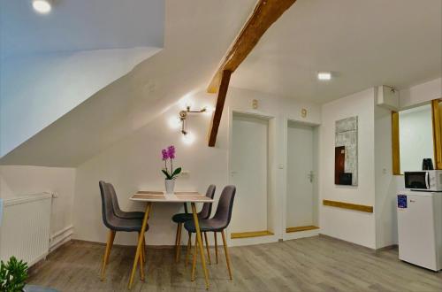 a kitchen and dining room with a table and chairs at LINA ROOMS in Ljubljana