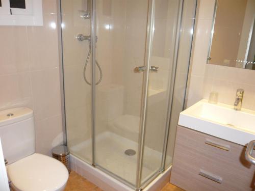 a bathroom with a shower and a toilet and a sink at Hostal BESTPRICE Barcelona Stadium in Barcelona
