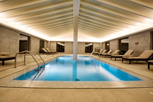 
a large swimming pool in a large room at Hotel Son Trobat Wellness & Spa in Sant Llorenç des Cardassar

