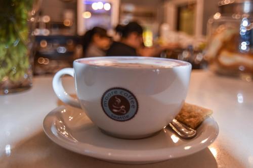 a cup of coffee sitting on a table at Moore Hotel in Seattle