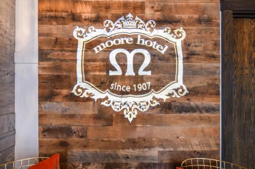 a sign for a house hotel on a wooden wall at Moore Hotel in Seattle