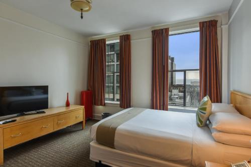 a hotel room with a bed and a large window at Moore Hotel in Seattle