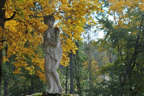 a statue of a boy standing in a park at Husby Säteri in Söderköping