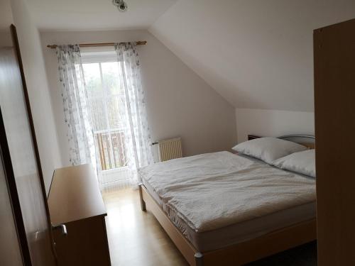 a bedroom with a bed and a large window at Eibenberger in Stubenberg