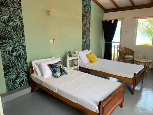 A bed or beds in a room at Airy Dale Villa and Guesthouse
