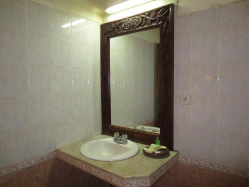 a bathroom with a sink and a mirror at Laghawa Beach Hotel in Sanur