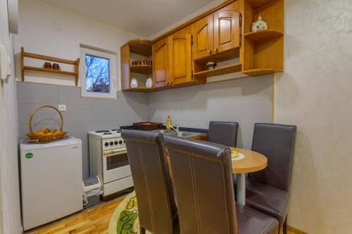 a kitchen with a table and chairs in a room at Konačište Dabić in Zlatibor