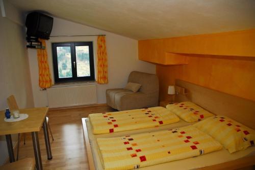 タクセンバッハにあるFerienhaus Yeraのベッドルーム1室(ベッド2台、テーブル、椅子付)