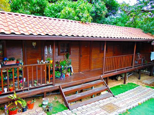 a small wooden house with a large deck at Cabañas Colindas in Panama City