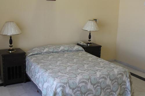 Ліжко або ліжка в номері Suites San Luis Villas