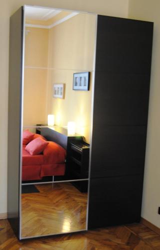 a mirror in front of a bedroom with a bed at Alma Clara B&B in Turin