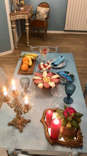 a table with food and candles on top of it at Il Giardino Segreto Arona, Charming Apartments in Arona
