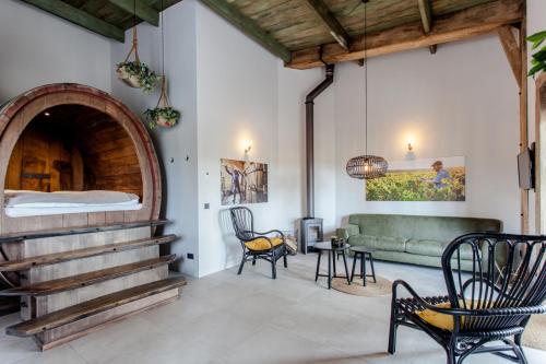 a living room with a couch and a fireplace at De Wijnlodge in Kootwijkerbroek
