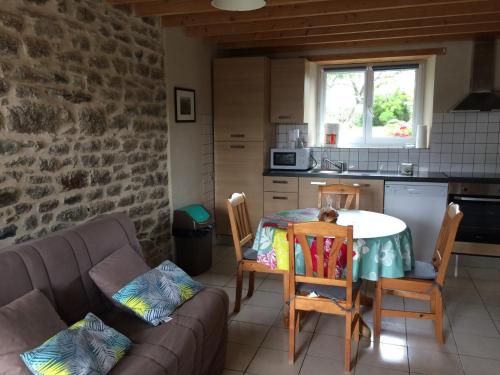 a living room with a table and a couch at Entre Terre et Mer in Réville