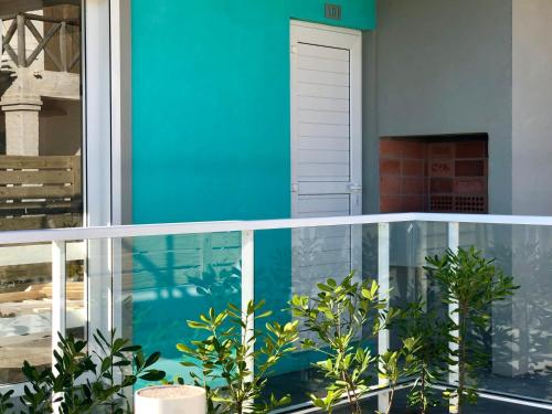 a balcony with a blue wall and some plants at Las Olas Aparts in La Paloma