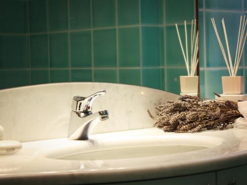 a bathroom with a sink with a plant at Bed And Breakfast 22 Garibaldi Home in Riccione