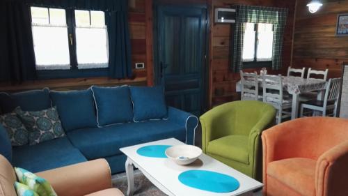 a living room with a couch and chairs and a table at Apartment Bajka in Mokra Gora