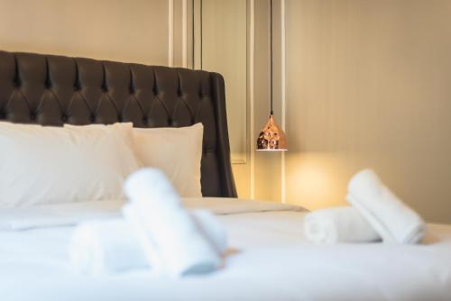 a bedroom with a large white bed with a black headboard at Syntagma Luxury Living One “LL1” Apartments in Athens