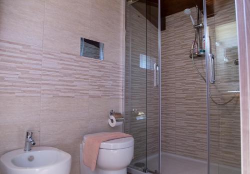 a bathroom with a shower and a toilet and a sink at Mansarda in centro al quarto piano in Capri Leone
